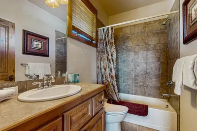 a bathroom with a sink and a toilet and a tub at Trailside Tranquility in Winter Park
