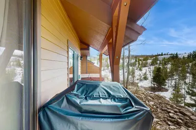a hot tub sitting on the side of a house at Trailside Tranquility in Winter Park