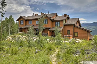 a large wooden house on top of a hill at Trailside Tranquility in Winter Park