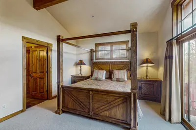 a bedroom with a four poster bed in a room at Trailside Tranquility in Winter Park