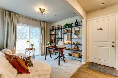 a living room with a door and a desk at 13 Mi to Dtwn Denver Spacious Home with Balcony! in Denver