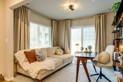 a living room with a couch and a table at 13 Mi to Dtwn Denver Spacious Home with Balcony! in Denver
