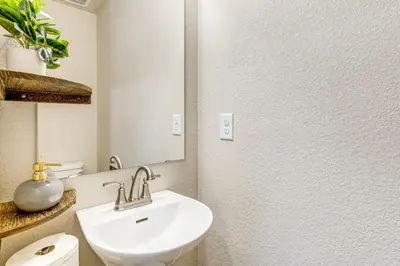 a bathroom with a sink and a mirror at 13 Mi to Dtwn Denver Spacious Home with Balcony! in Denver