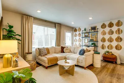 a living room with a couch and a table at 13 Mi to Dtwn Denver Spacious Home with Balcony! in Denver