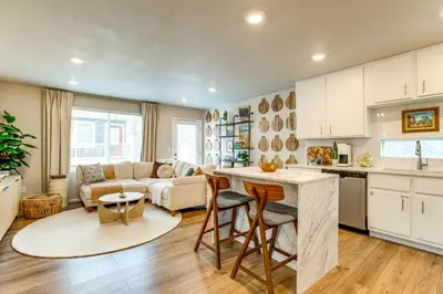 a kitchen and living room with a couch and a table at 13 Mi to Dtwn Denver Spacious Home with Balcony! in Denver