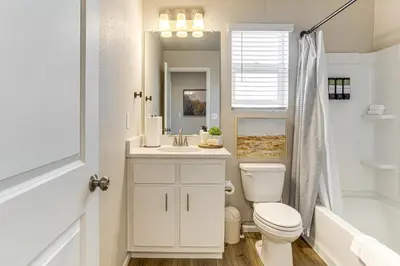a white bathroom with a toilet and a sink at 13 Mi to Dtwn Denver Spacious Home with Balcony! in Denver