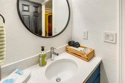 a bathroom with a sink and a mirror at Southern Comfort at the Blue Door in Sloan Lake in Denver