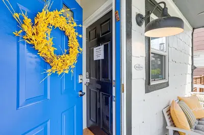 a blue door with a yellow wreath on it at Southern Comfort at the Blue Door in Sloan Lake in Denver