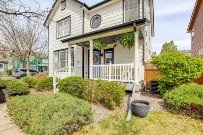a white house with a porch and bushes at Southern Comfort at the Blue Door in Sloan Lake in Denver