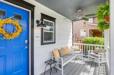 a front porch with a blue door and chairs at Southern Comfort at the Blue Door in Sloan Lake in Denver