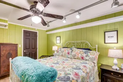 a bedroom with a bed and a ceiling fan at Southern Comfort at the Blue Door in Sloan Lake in Denver