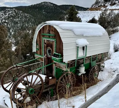 an old green and white carriage with a house on it at Special Glamping Accommodation Ideal for Nature Lovers in Golden, Colorado in Golden