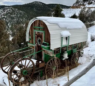 an old green and white carriage in the snow at Special Glamping Accommodation Ideal for Nature Lovers in Golden, Colorado in Golden