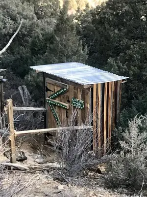 a wooden out house with a roof on a field at Special Glamping Accommodation Ideal for Nature Lovers in Golden, Colorado in Golden