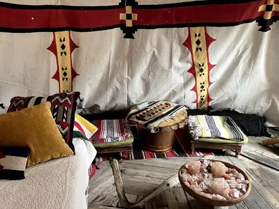 a room with a bed and a table in a tent at Raven's Ridge Luxurious Tipi in Golden, Colorado in Golden