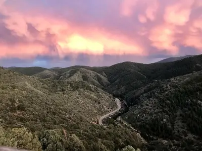 a view of a winding road in the mountains at Raven's Ridge Luxurious Tipi in Golden, Colorado in Golden