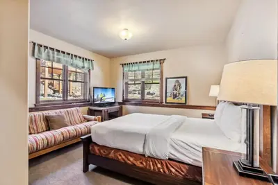 a bedroom with a bed and a couch at Spacious Ski Townhome with Game Room Fun in Breckenridge