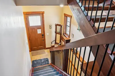 a staircase in a home with a wooden door at Spacious Ski Townhome with Game Room Fun in Breckenridge