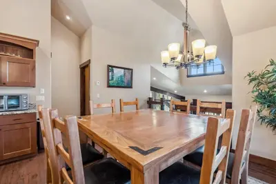 a kitchen and dining room with a wooden table and chairs at Spacious Ski Townhome with Game Room Fun in Breckenridge