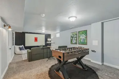 a living room with a foosball table in a room at Projector Nights And Park Delights Designer Reno in Arvada