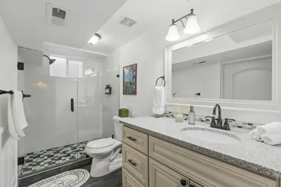 a bathroom with a toilet and a sink and a shower at Projector Nights And Park Delights Designer Reno in Arvada