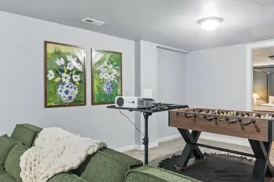 a living room with a couch and a table at Projector Nights And Park Delights Designer Reno in Arvada