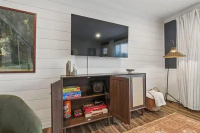 a living room with a tv on a wall at Projector Nights And Park Delights Designer Reno in Arvada