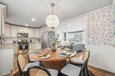 a kitchen and dining room with a table and chairs at Projector Nights And Park Delights Designer Reno in Arvada