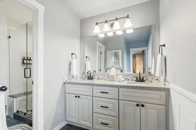 a bathroom with a sink and a large mirror at Projector Nights And Park Delights Designer Reno in Arvada