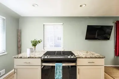 a kitchen with a stove and a counter top at Movie Theater + Hot Tub | Game Yard | Sleeps 10! in Arvada