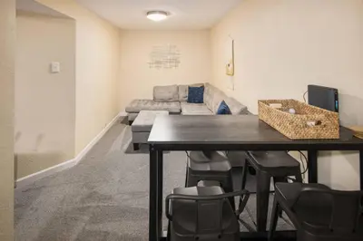 a living room with a table and a couch at Family Retreat! By Denver + Hot Tub, Sleeps 10! in Wheat Ridge