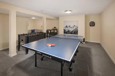 a ping pong table in a room with a ping pong ball at Family Retreat! By Denver + Hot Tub, Sleeps 10! in Wheat Ridge