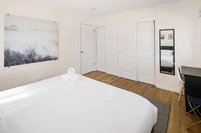 a white bedroom with a bed and a desk at Family Retreat! By Denver + Hot Tub, Sleeps 10! in Wheat Ridge