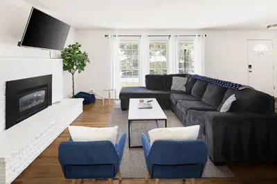 a living room with a couch and a fireplace at Family Retreat! By Denver + Hot Tub, Sleeps 10! in Wheat Ridge