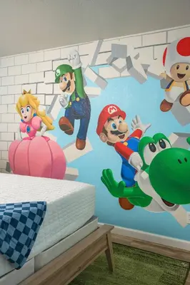 a bedroom with a wall mural of mario characters at Mini Golf • Fire Pit • Hot Tub | Game House for 14 in Arvada