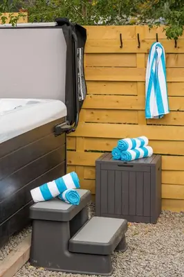 a bed and a bench next to a wooden fence at Mini Golf • Fire Pit • Hot Tub | Game House for 14 in Arvada