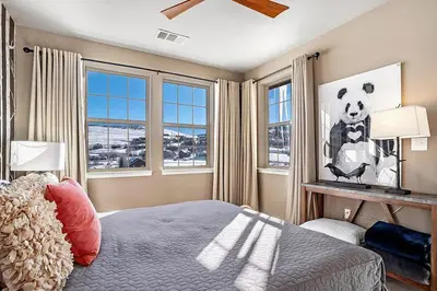 a bedroom with a panda bear picture on the wall at Aspen Meadows C-303, 0017 in Granby