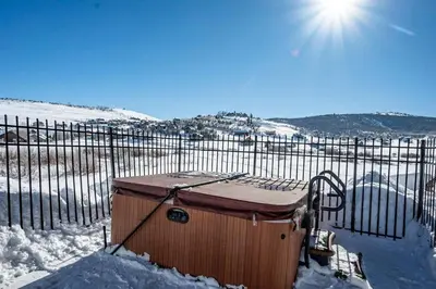 a container sitting in the snow next to a fence at Aspen Meadows C-303, 0017 in Granby