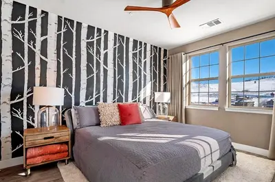 a bedroom with a bed and a large window at Aspen Meadows C-303, 0017 in Granby