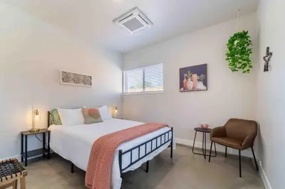 a bedroom with a bed and a chair at Morrison Getaway - 2BR House BBQ Free Parking in Morrison