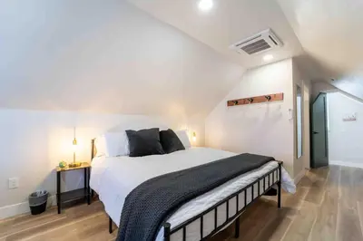 a bedroom with a large bed in a attic at Morrison Getaway - 2BR House BBQ Free Parking in Morrison