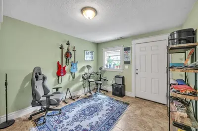 a bedroom with green walls and a room with a desk and chairs at Stylish 2-Story Home - Perfect Denver Location home in Denver