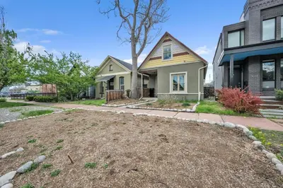 a house with a large yard in front of it at Stylish 2-Story Home - Perfect Denver Location home in Denver