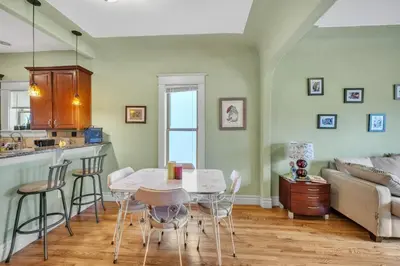 a kitchen and living room with a table and chairs at Stylish 2-Story Home - Perfect Denver Location home in Denver