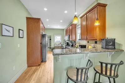 a kitchen with two chairs and a counter at Stylish 2-Story Home - Perfect Denver Location home in Denver
