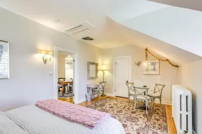 a bedroom with a bed and a table and chairs at Historic French Consulate! Cap Hill Area, Walkable in Denver