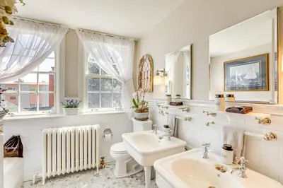 a white bathroom with a sink and a toilet at Historic French Consulate! Cap Hill Area, Walkable in Denver