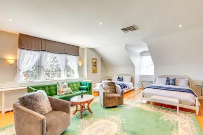 a bedroom with a bed and a living room at Historic French Consulate! Cap Hill Area, Walkable in Denver