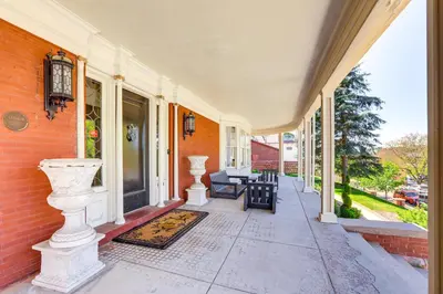a porch of a house with two white vases at Historic French Consulate! Cap Hill Area, Walkable in Denver