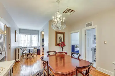 a dining room and living room with a table and chairs at Historic French Consulate! Cap Hill Area, Walkable in Denver
